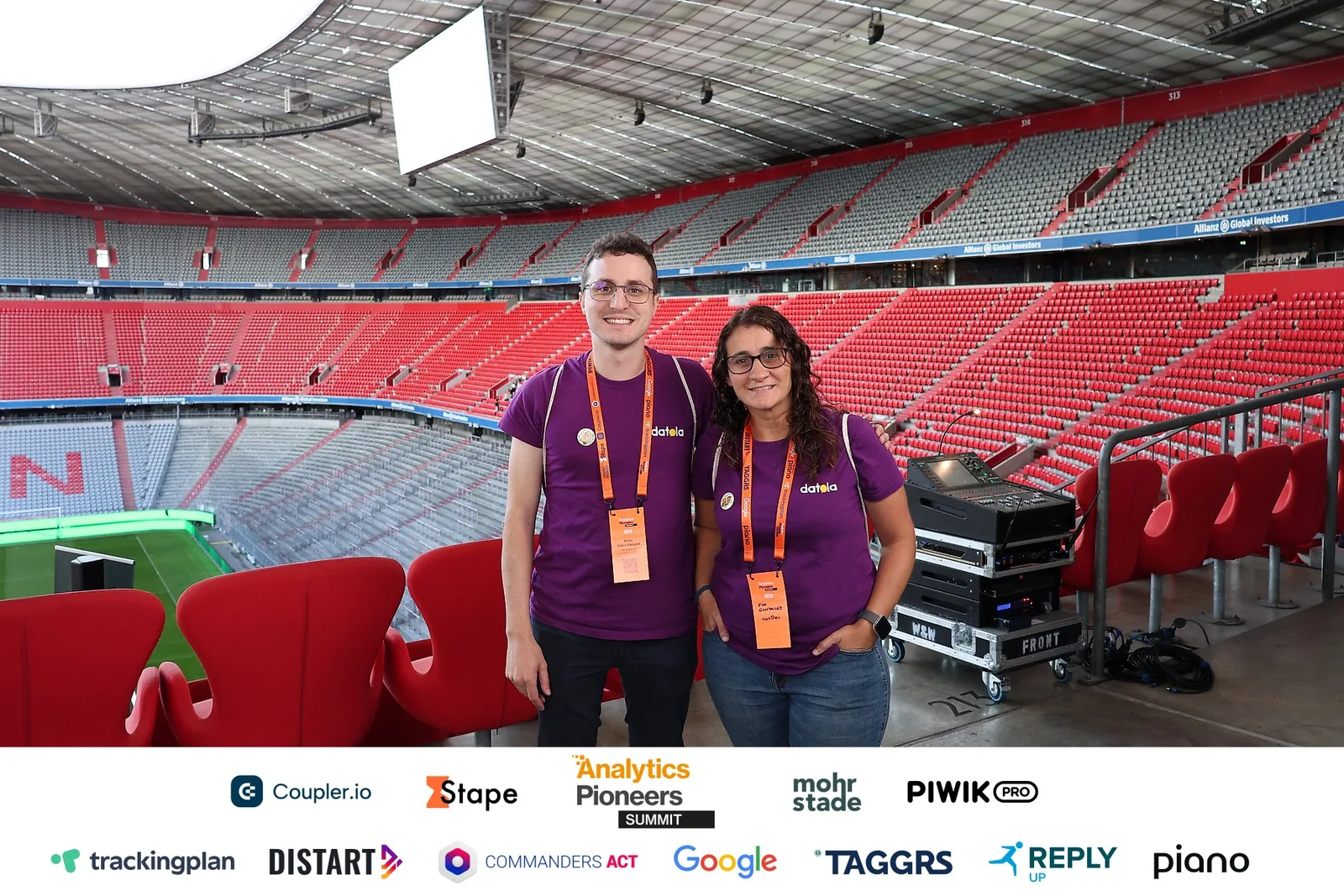 Brais and Eva from nosDeu pose with their event badges in the Allianz Arena stands